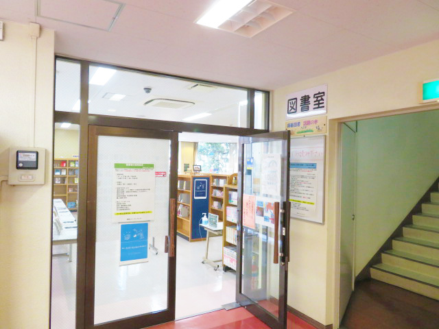 階段傍にあり扉が片方開いた図書室入り口の写真